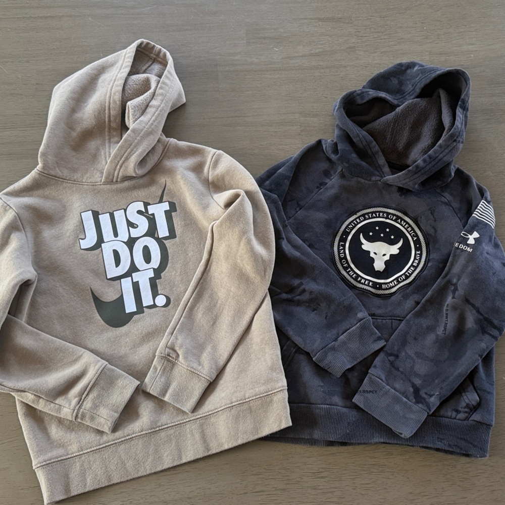 Nike Just Do It Beige Hoodie and UA Land of the Free Black Graphic Hoodie